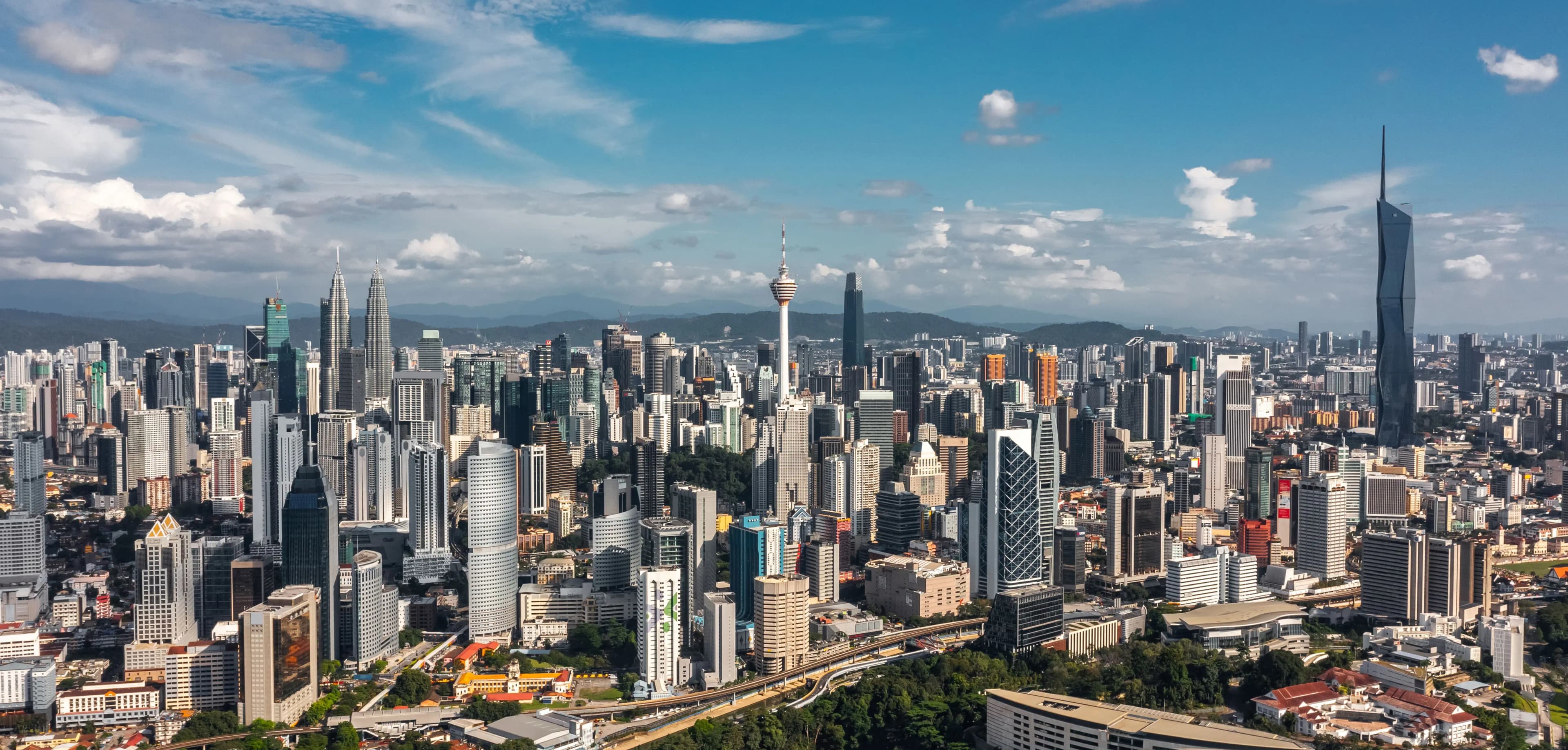 Panoramic view of Kuala Lumpur corridors and dense urban neighborhoods.